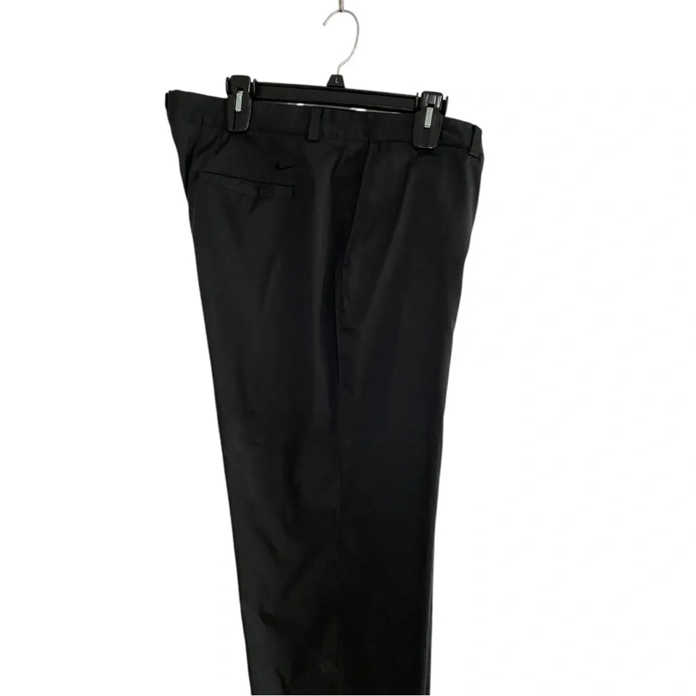 Nike Golf Tour Performance Dri-Fit black golf pants. Flat front Nike logo 40/26
